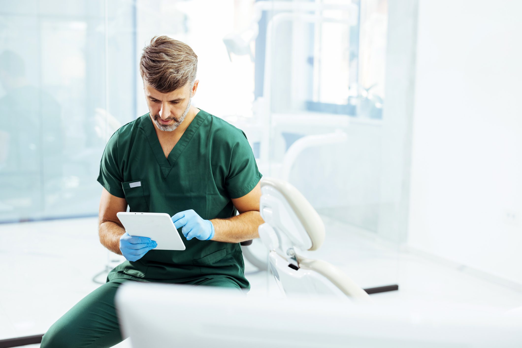 Dentist reviewing patient information on tablet