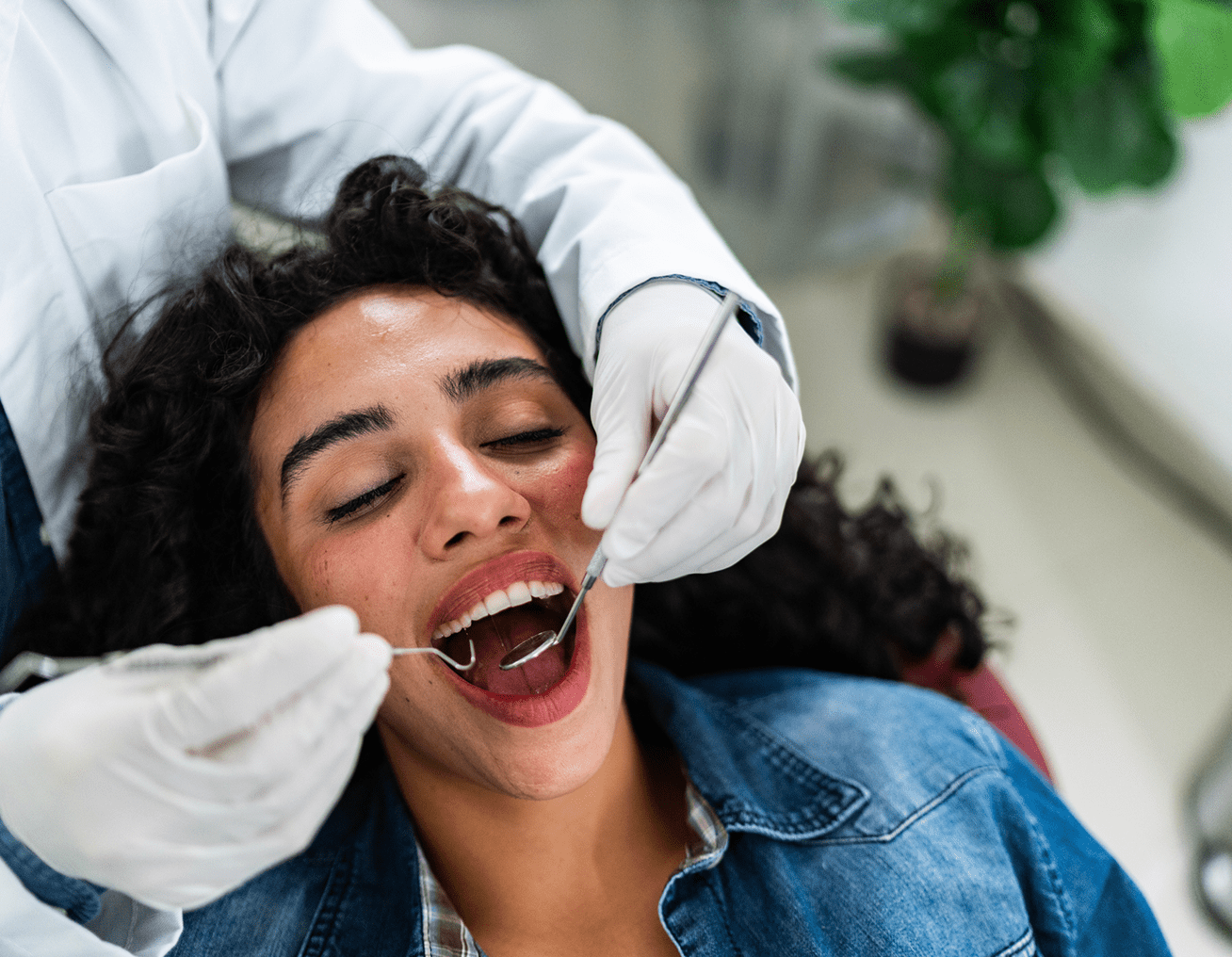 Dentist examining patient's teeth