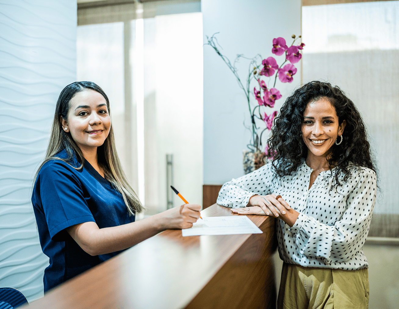 Receptionist assisting a smiling client
