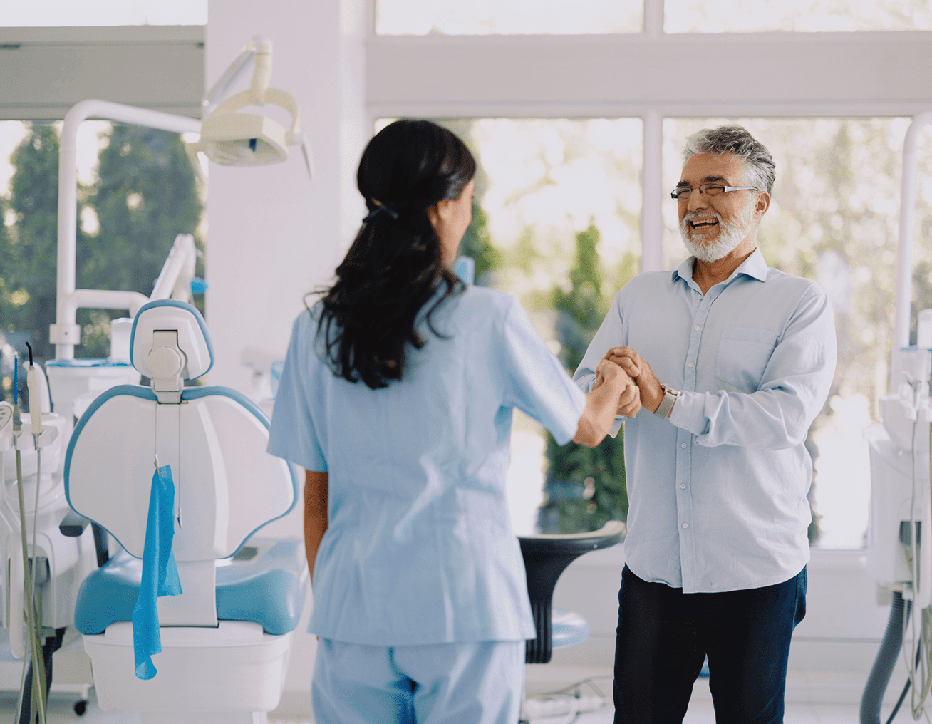Dentist greeting a happy patient